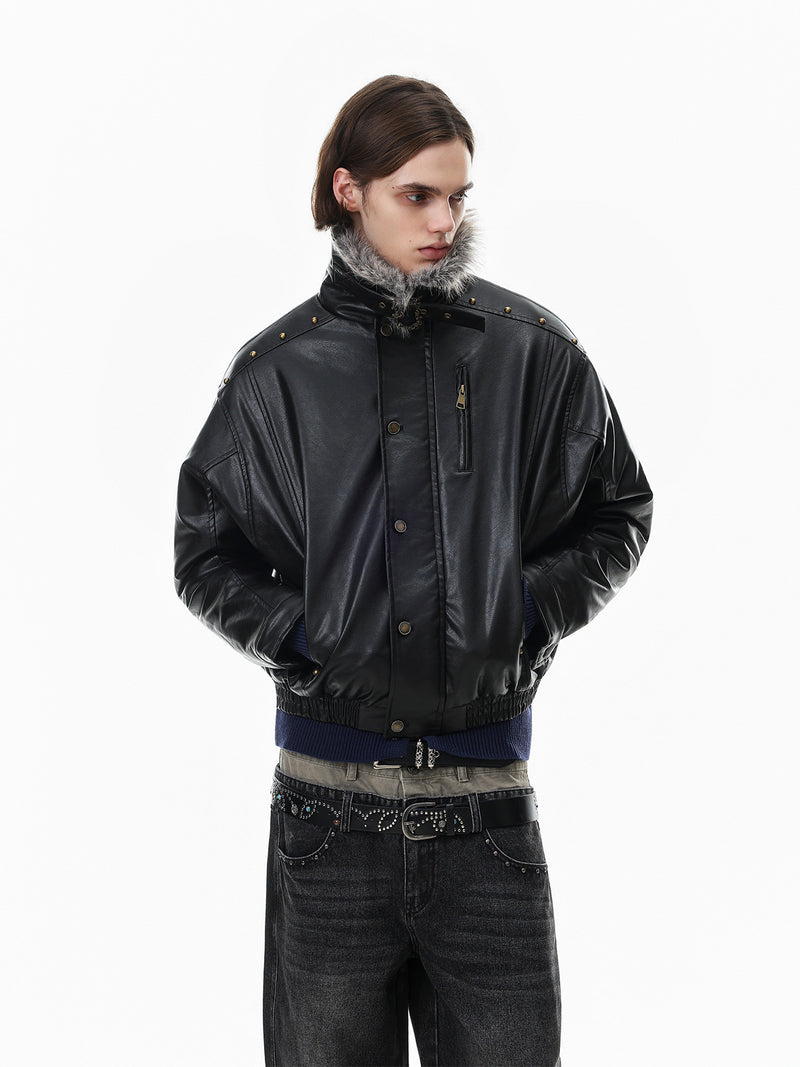 Model wearing a black faux leather bomber jacket from a side-front view with raised collar