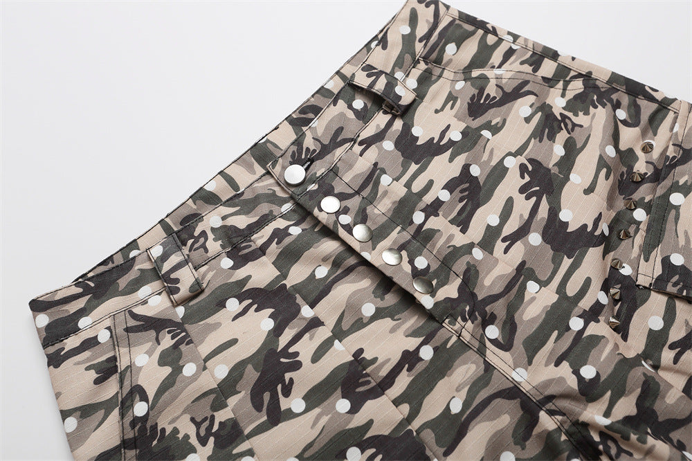 Diagonal close-up of camo cargo shorts showing waistband, button fly, and pocket flaps