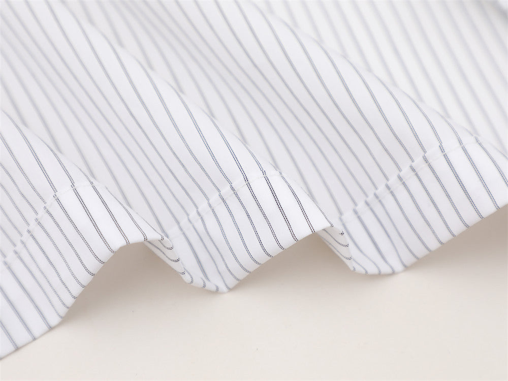 White striped shirt hem with scalloped side seams close-up
