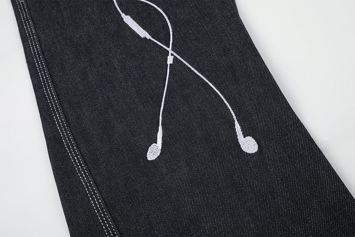 Jean baggy à jambes larges avec broderies et patch en cuir motif notes de musique — Denim noir brut