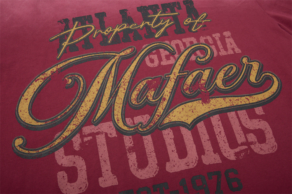 Close-up of front graphic on burgundy long sleeve shirt with distressed lettering