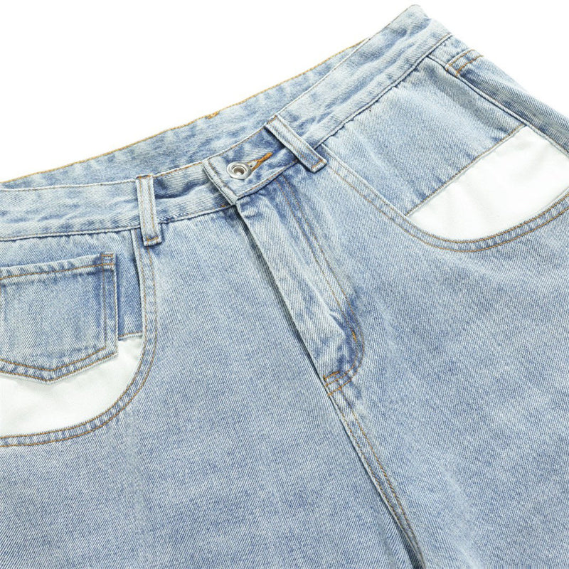 Close-up of light wash jeans waistband, front pockets, and button fly