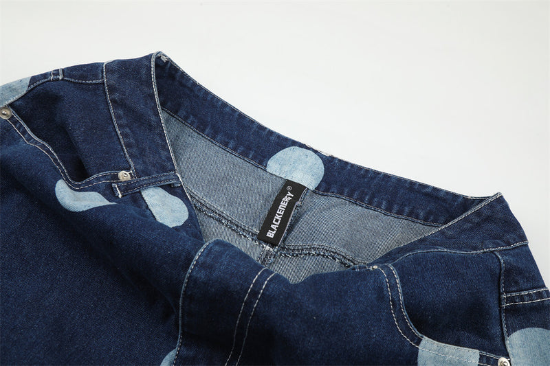 Inside waistband of dark wash jeans with brand label and polka dots
