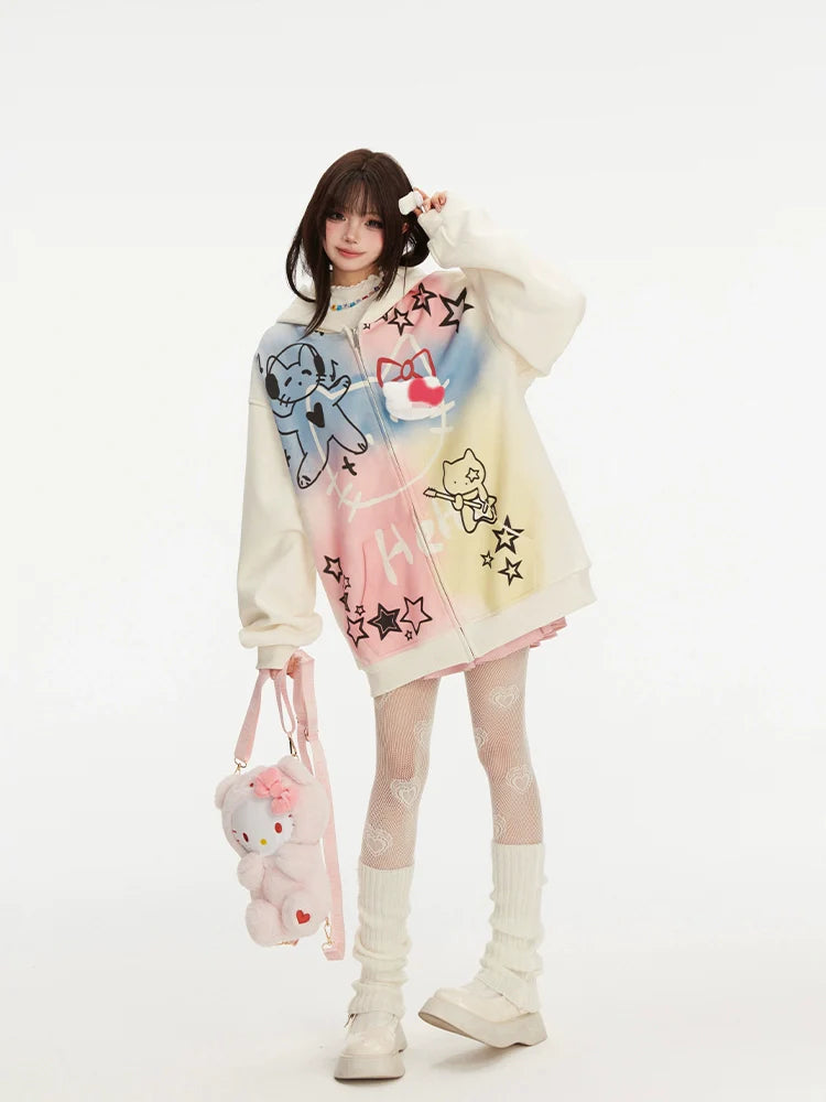 Against a plain background, a person wears Seakoff's Pastel Cat Graffiti Hoodie—an oversized full-zip hoodie adorned with colorful cat and star graphics. Complemented by white patterned tights, beige boots, and a plush pink bag, their dark hair with bangs adds to the streetwear charm.