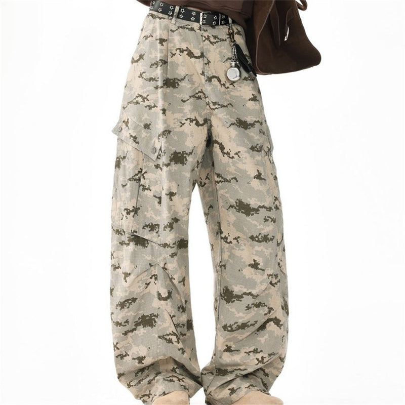 Wide-leg desert camo cargo pants on model with pleated front and side pockets