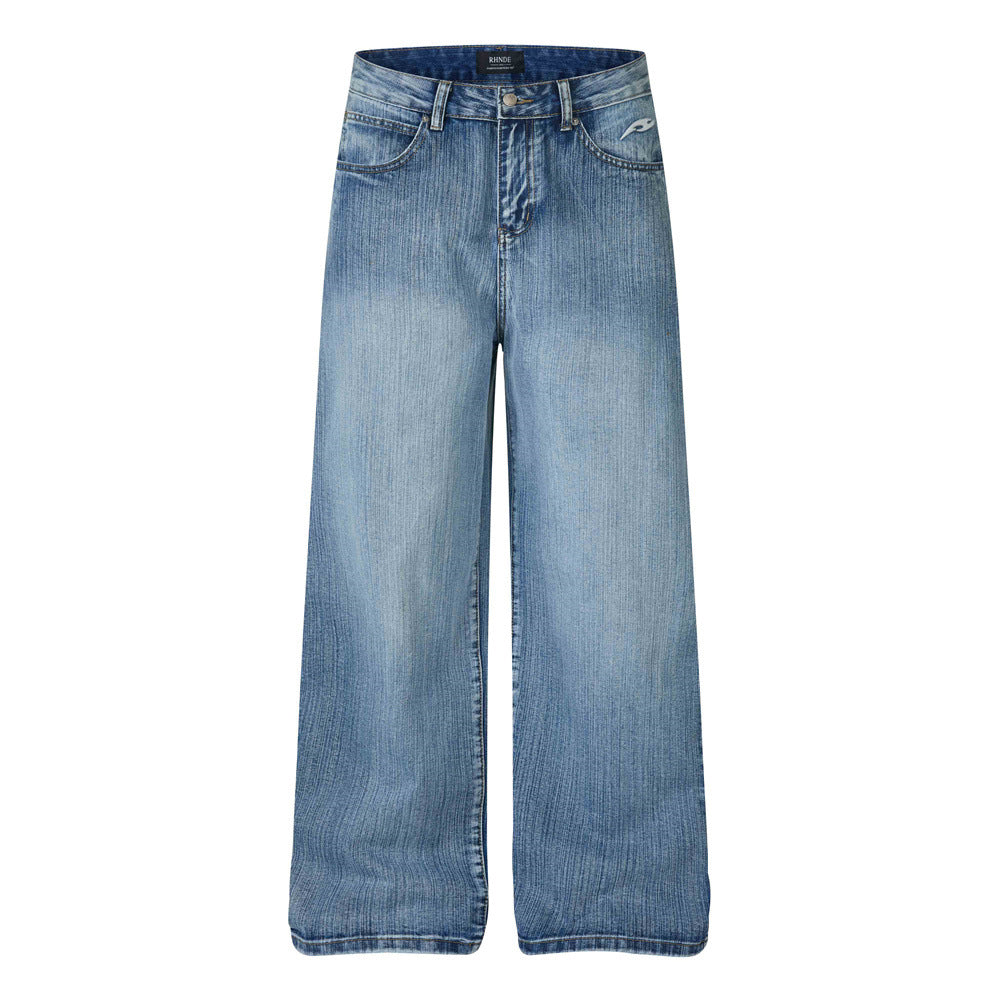 Men's wide-leg washed denim jeans with tribal wing graphic print on back panels in red, white, and black
