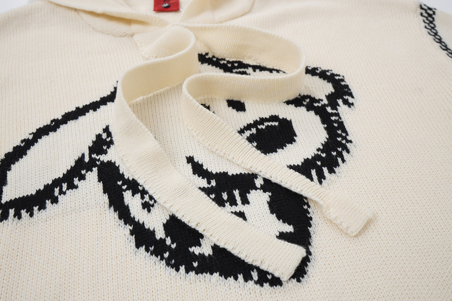 Pull à capuche oversize en maille jacquard avec grand motif graphique sur le devant