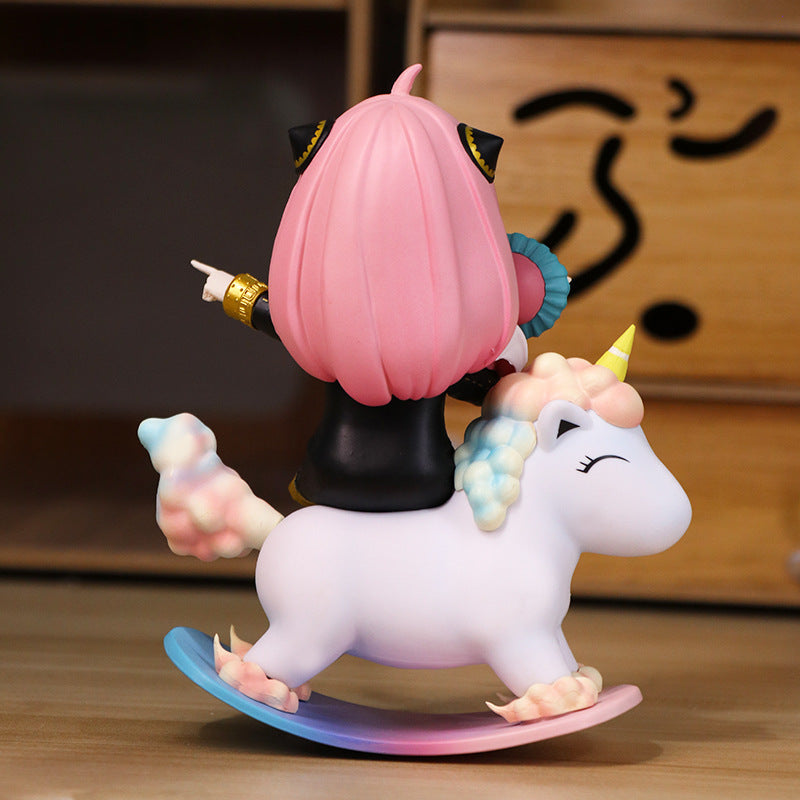 The Spy x Family Anya Forger PVC Figure features a small, 15 cm Anya with long pink hair on a rocking unicorn. She wears a dark outfit and points forward; the toy&