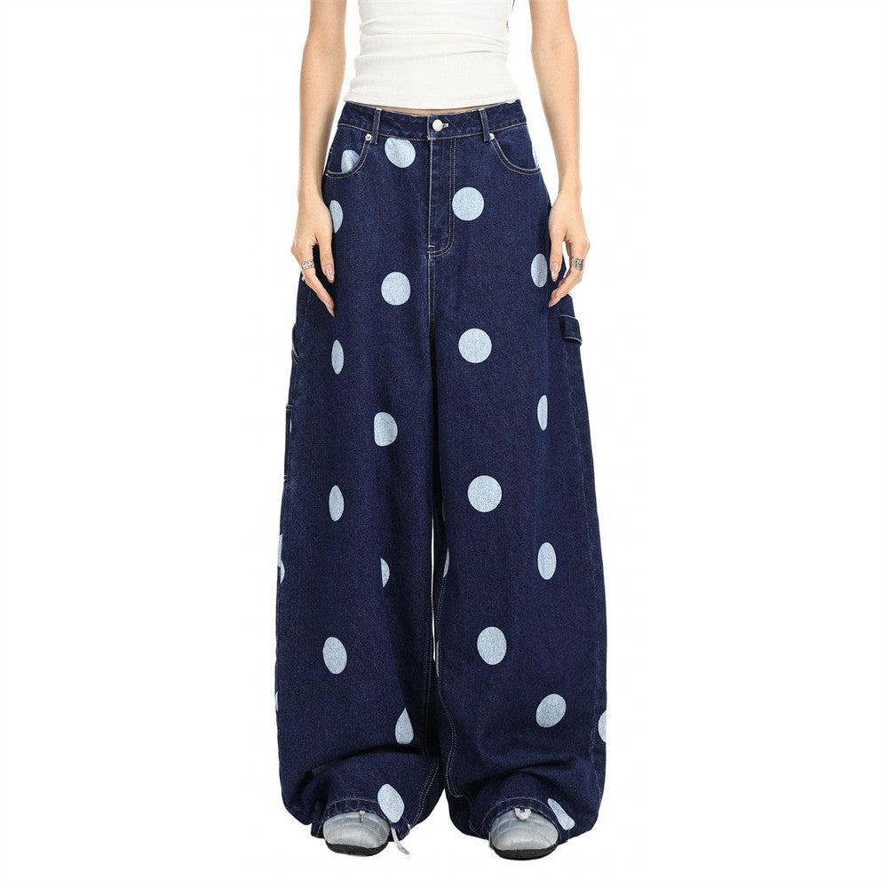 Model wearing oversized dark wash polka dot jeans, front view