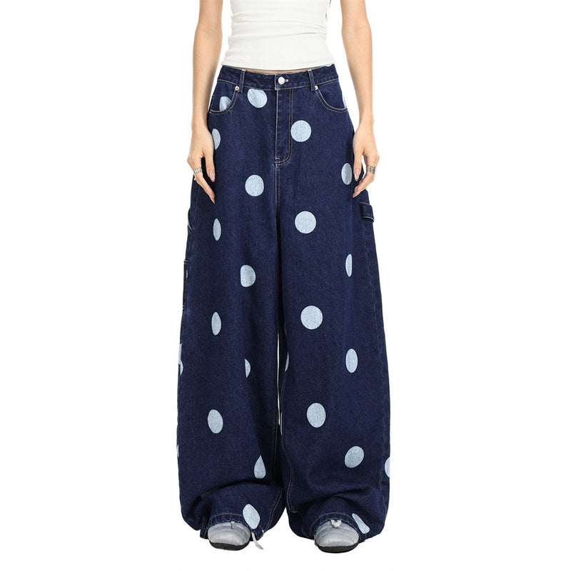 Model wearing oversized dark wash polka dot jeans, front view