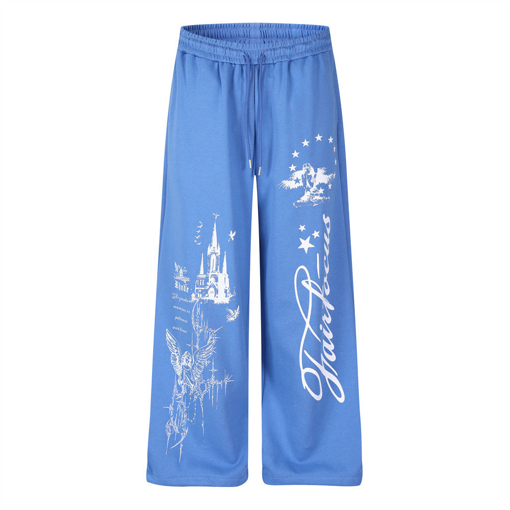 Wide-leg sweatpants in blue with white castle, angel, and star graphic print and Fairfocus cursive script on the leg