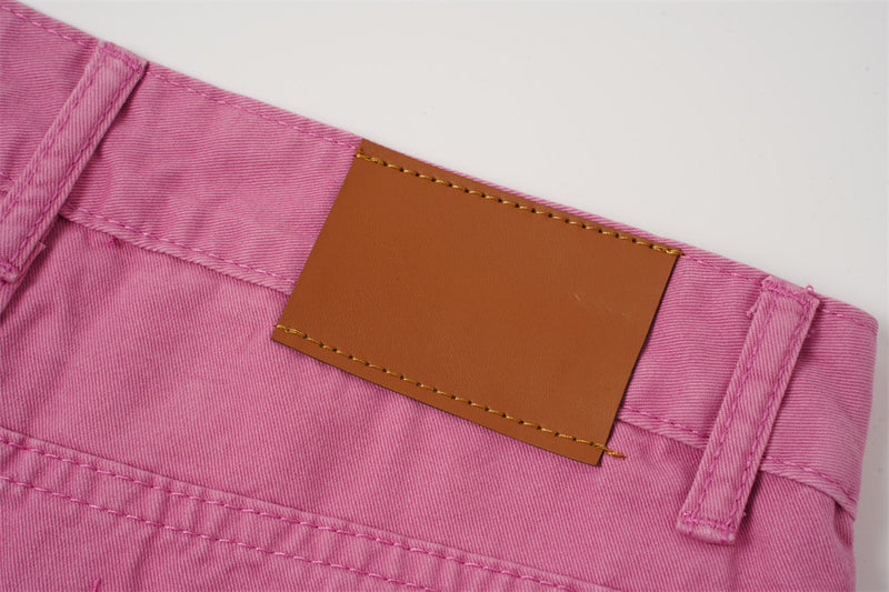 Close-up of brown label patch on rose pink shorts waistband