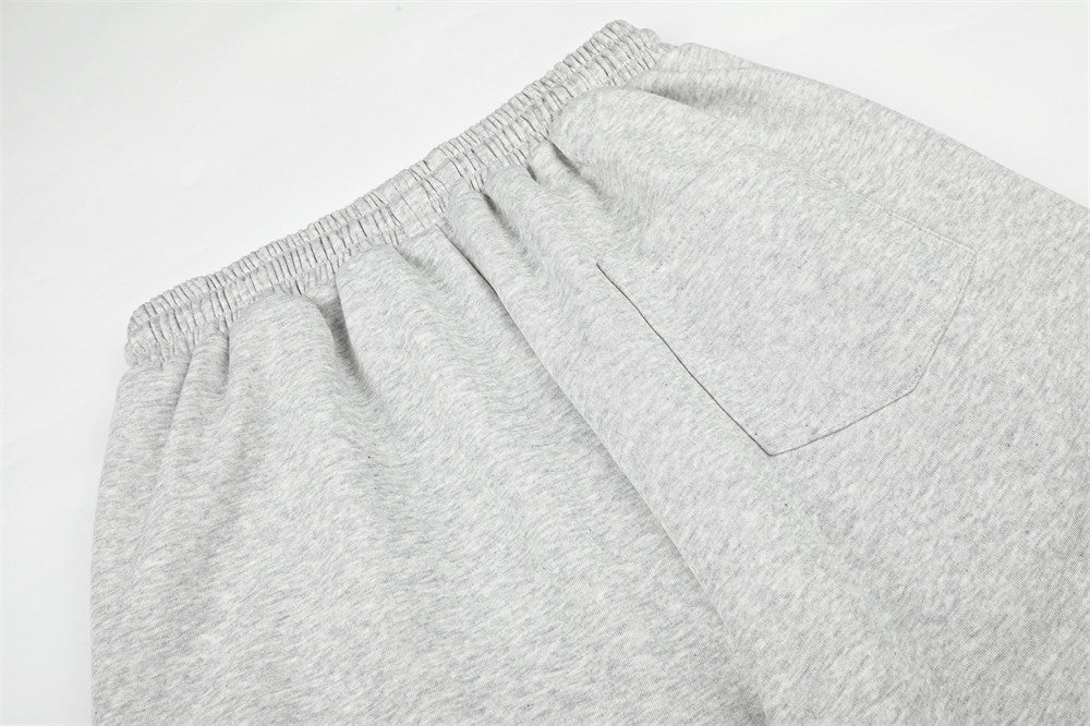 Close-up of gray sweatpants back pocket and gathered elastic waist