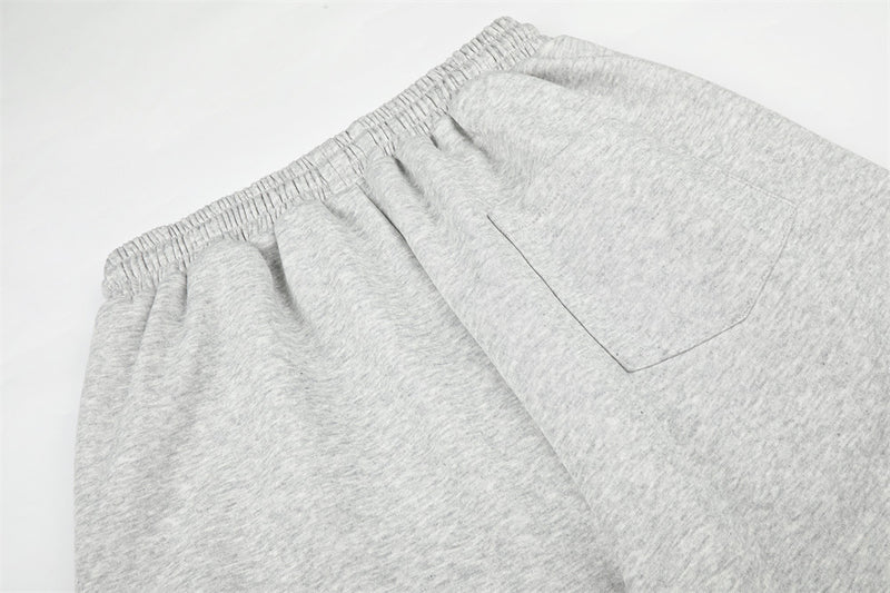 Close-up of gray sweatpants back pocket and gathered elastic waist