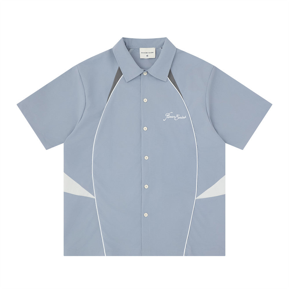 Men's color block racing short sleeve shirt in steel blue with grey and white contrast panels and embroidered chest logo