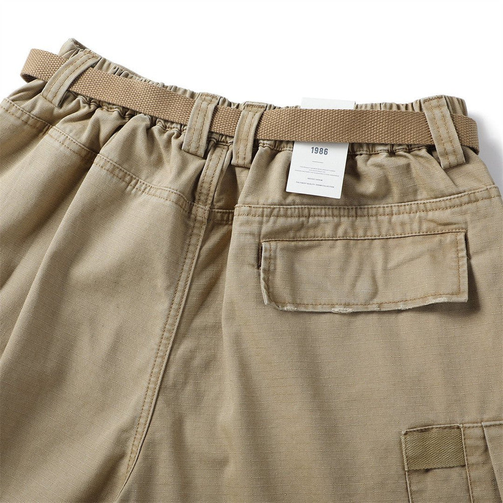 Back waist of khaki cargo shorts with belt loop, elastic gather, and flap pocket