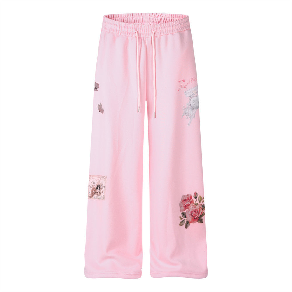 Wide-leg sweatpants in pastel pink with 3D rose bouquet, butterfly, and vintage carriage graphic prints and elastic drawstrin