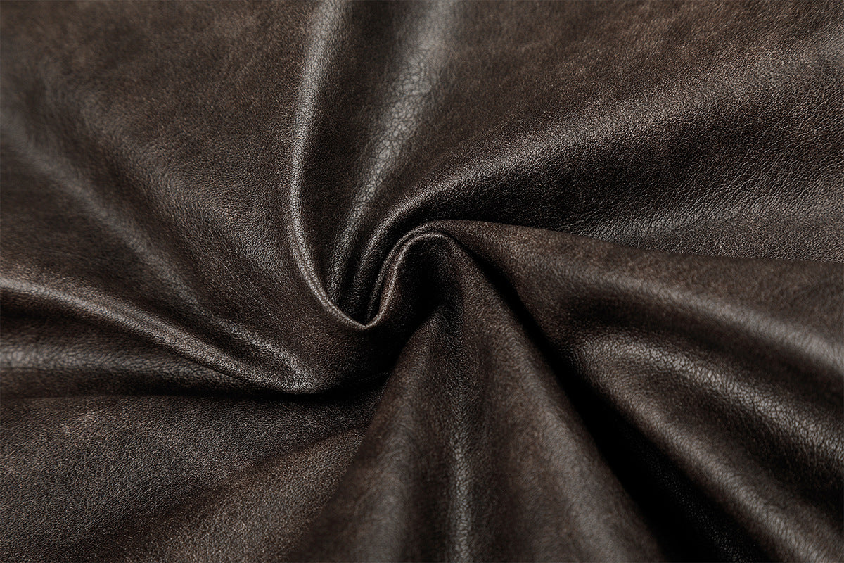 Close-up showing the smooth, textured brown faux leather jacket material