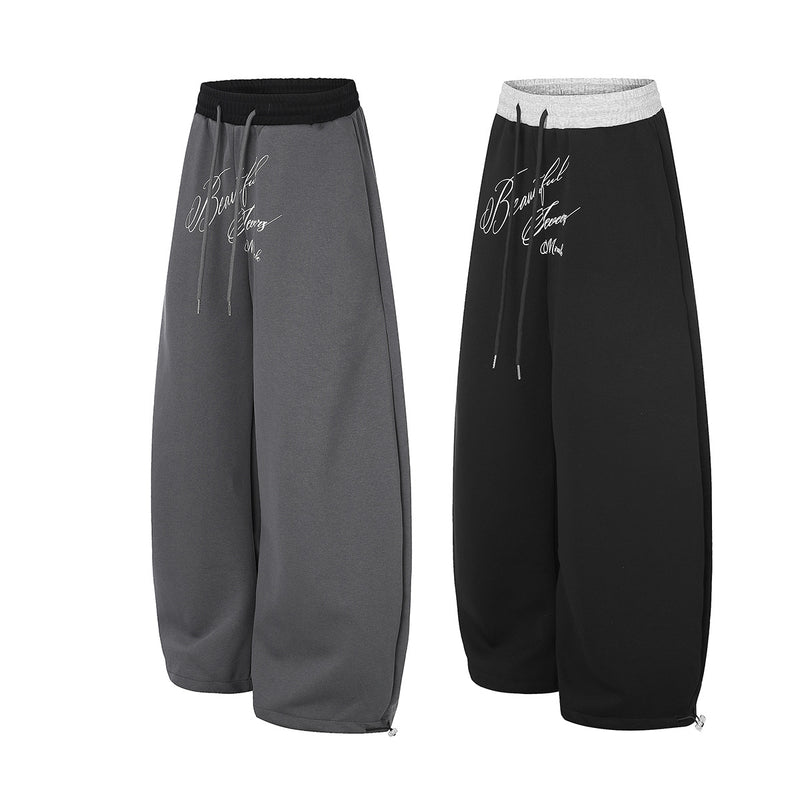 Pantalon de survêtement large à inscription et ceinture contrastante