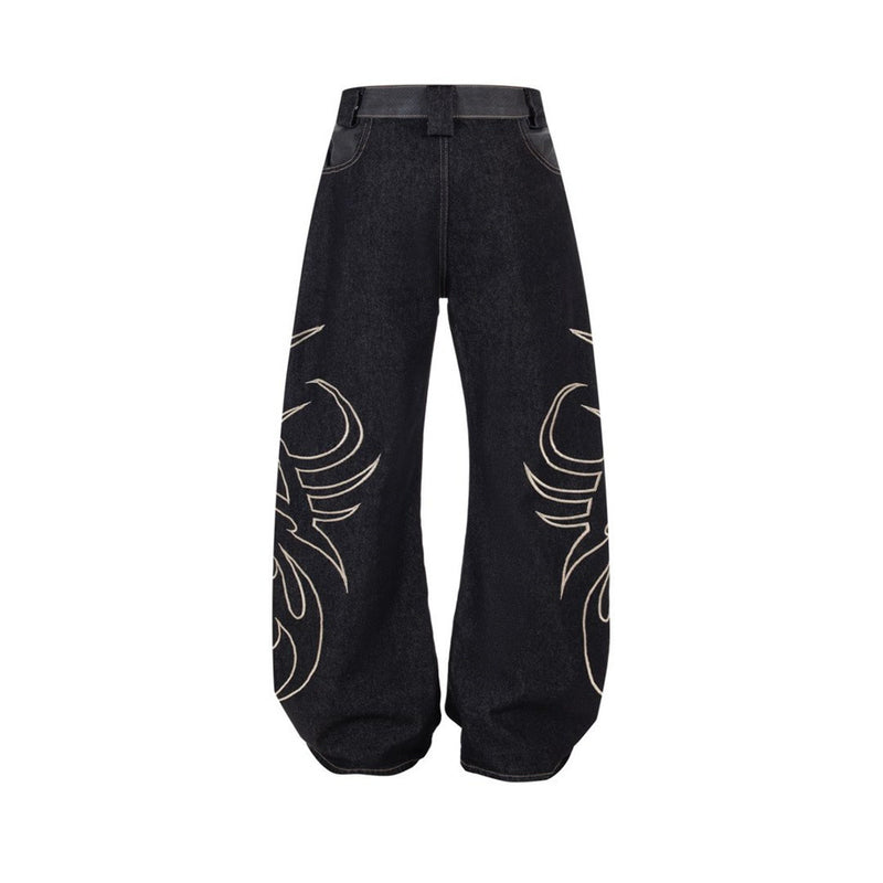 Back view of black wide-leg jeans with tribal flame embroidery along both legs