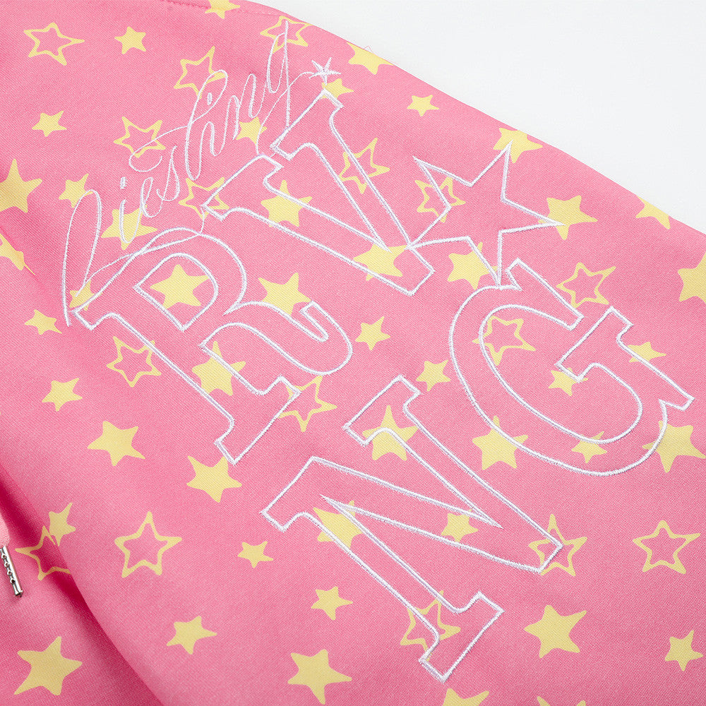 Close-up of pink star print sweatpants front graphic print with stars and lettering