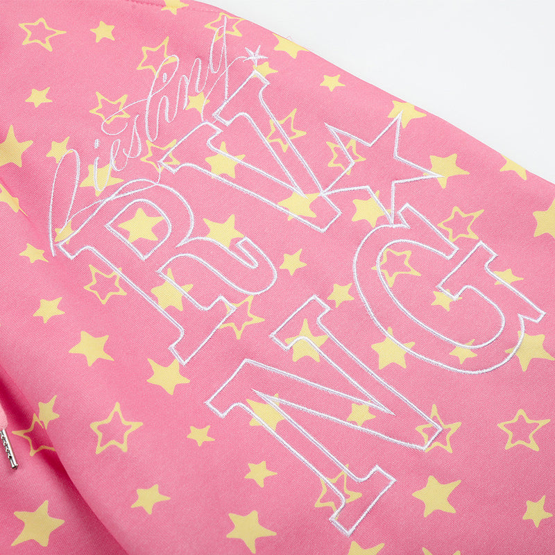 Close-up of pink star print sweatpants front graphic print with stars and lettering