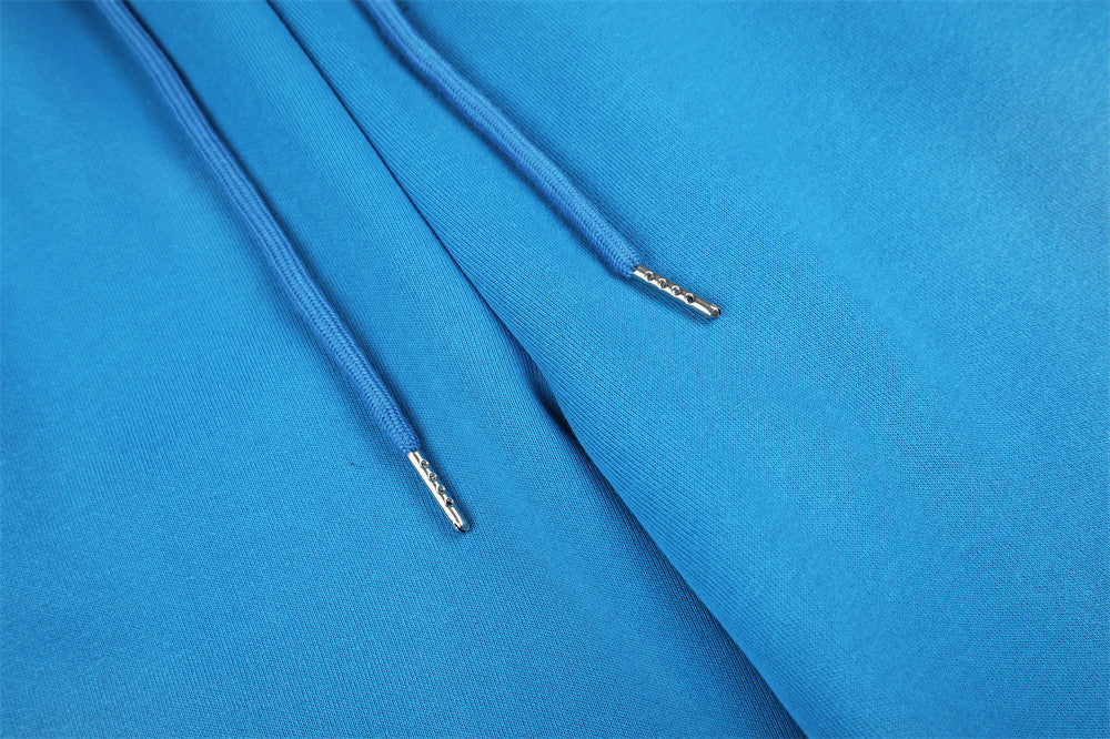 Close-up of blue sweatpants drawstring ends and soft knit fabric texture