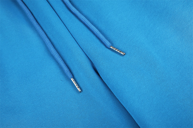 Close-up of blue sweatpants drawstring ends and soft knit fabric texture