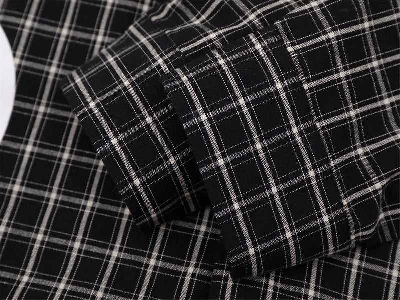 Close-up of layered black plaid shirt sleeves and cuff seams