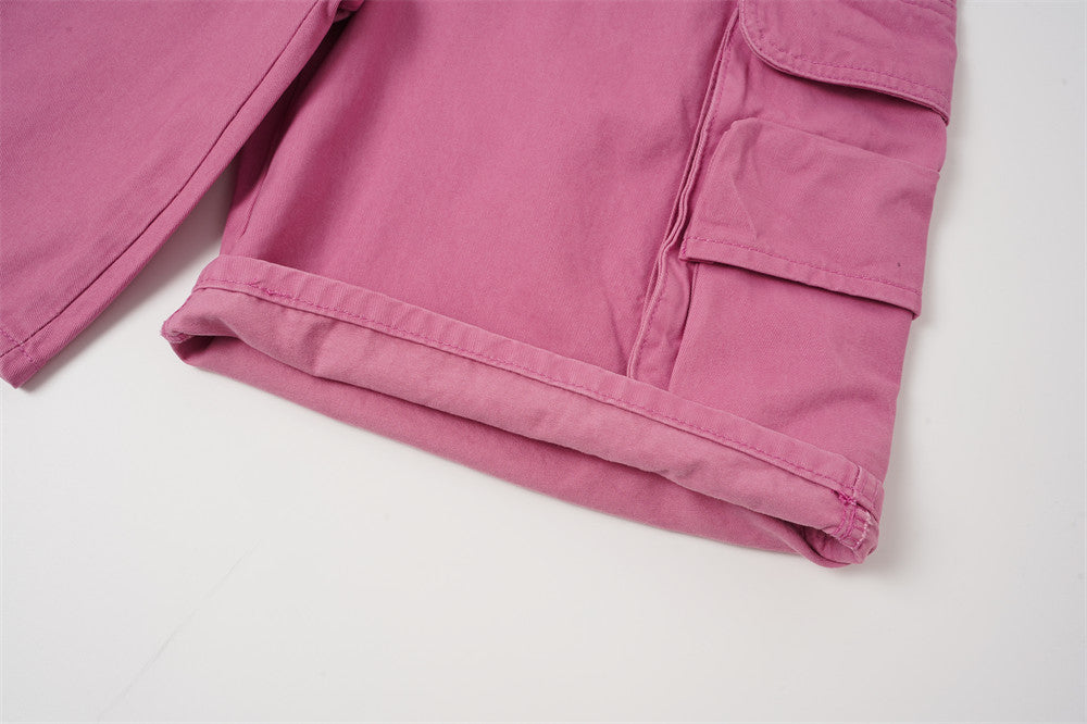 Close-up of hem and side cargo pocket on rose pink shorts