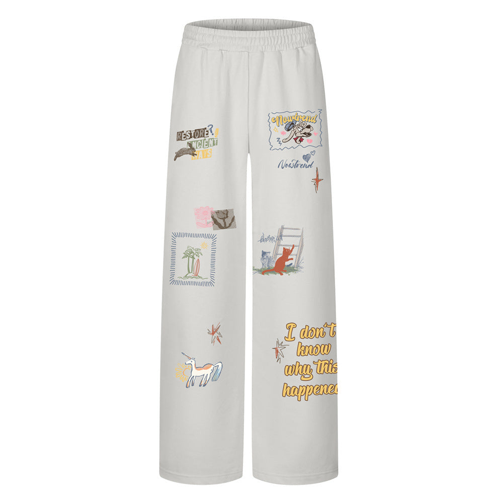 Men's wide-leg sweatpants with all-over cartoon and slogan graphic print in off-white colorway, front view