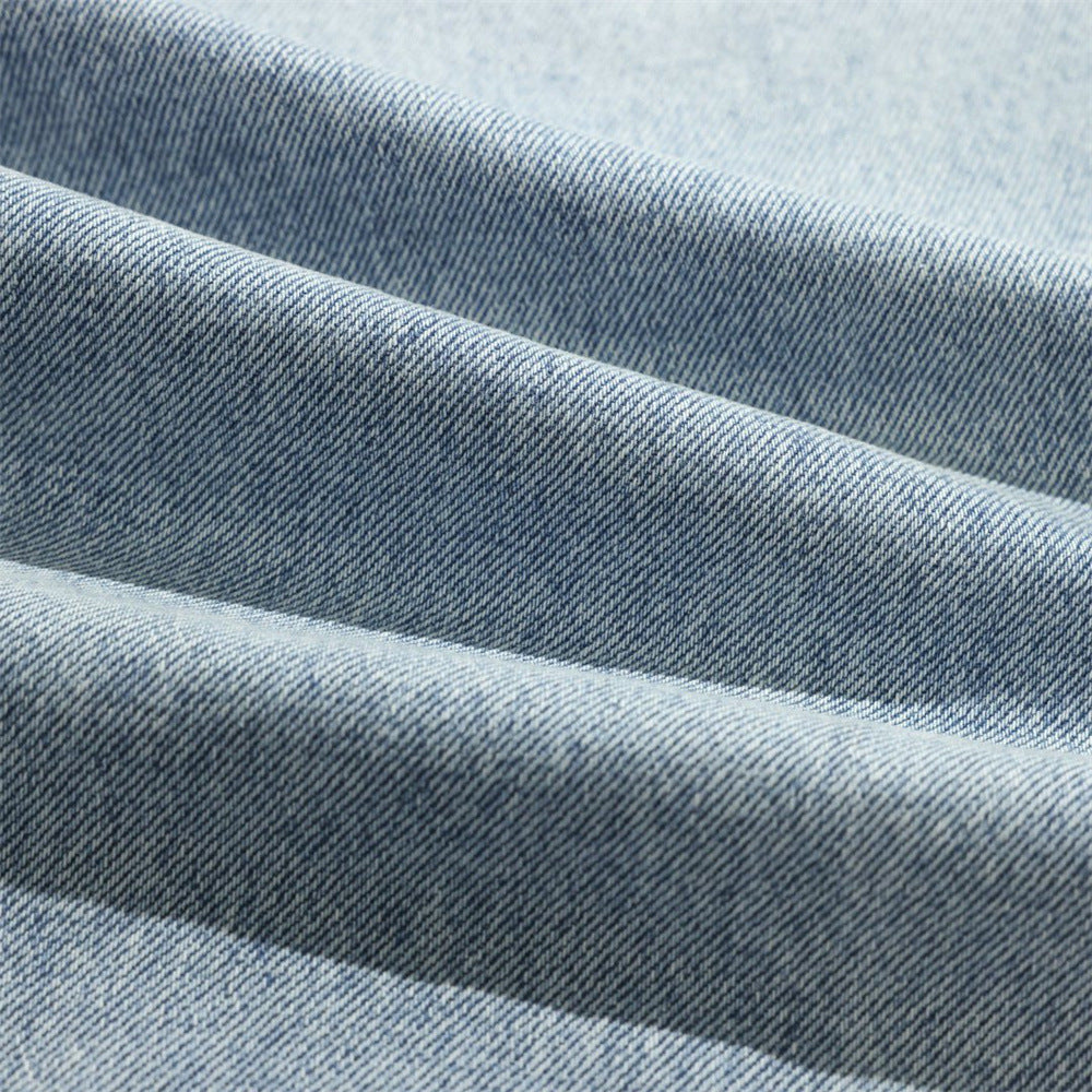Close-up of light wash denim fabric texture and folded drape
