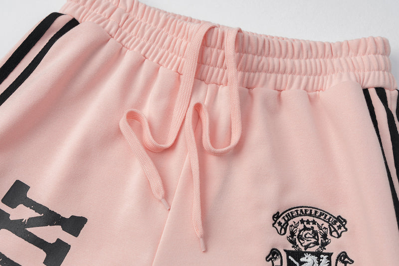 Pantalon de survêtement wide leg – Rose délavé avec bande latérale et écusson brodé