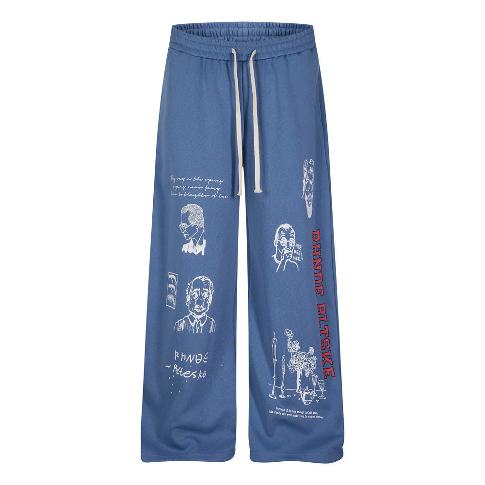 Men's wide-leg sweatpants in slate blue with abstract portrait illustration print and varsity lettering graphic down the leg