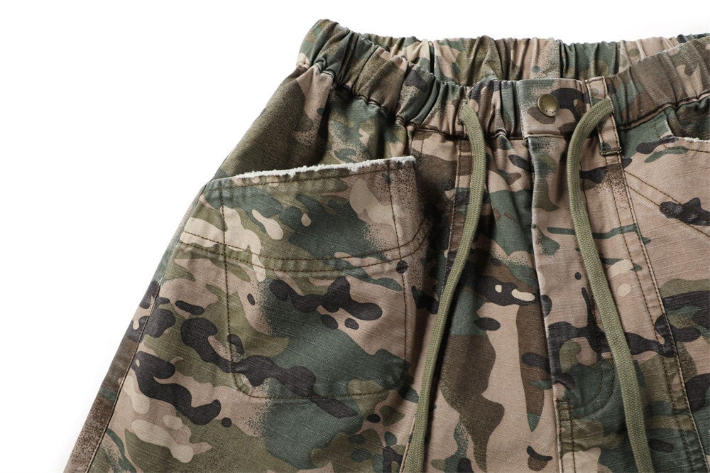 Close-up of camouflage shorts front pocket and elastic waistband