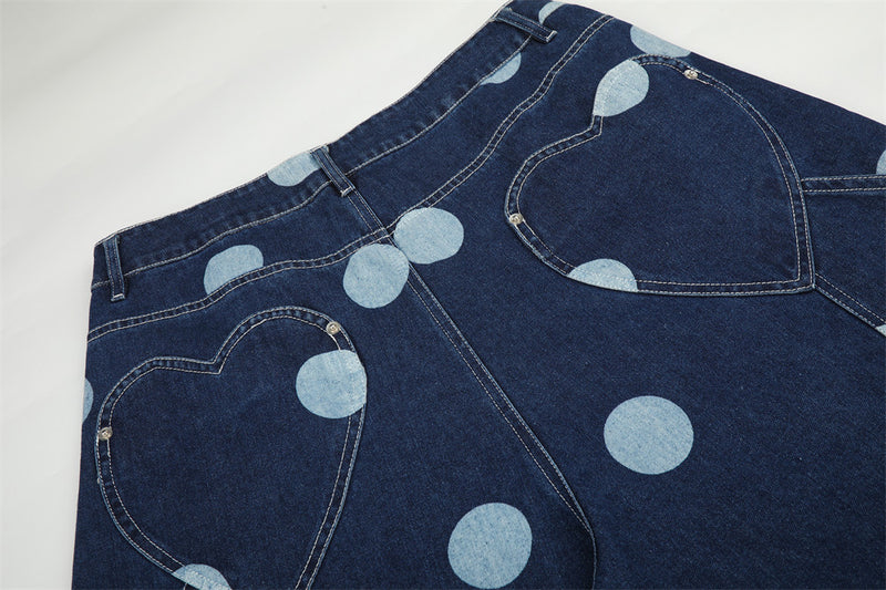 Close-up of back pockets on dark blue jeans with heart-shaped stitching