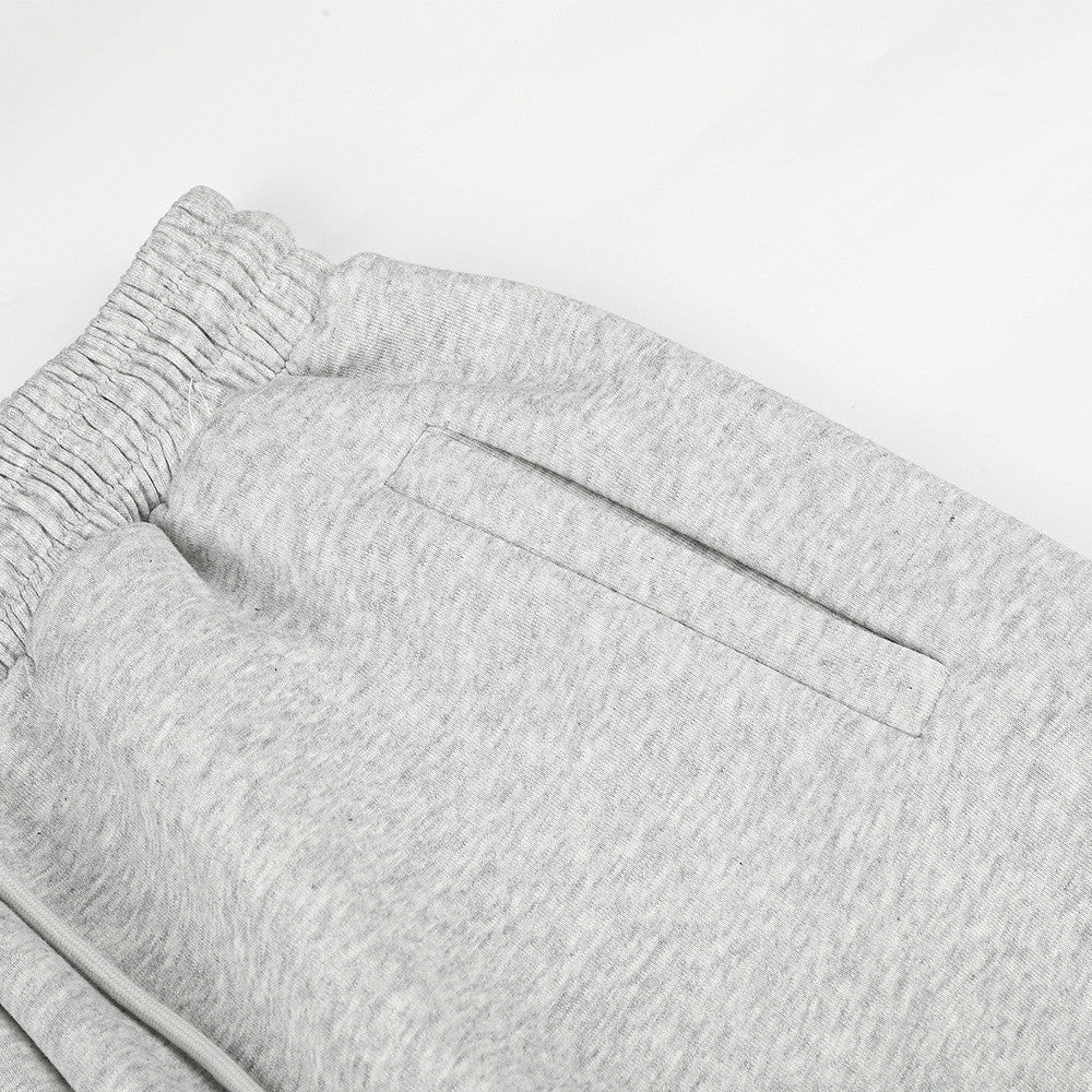 Close-up of gray sweatpants back pocket and elastic waistband