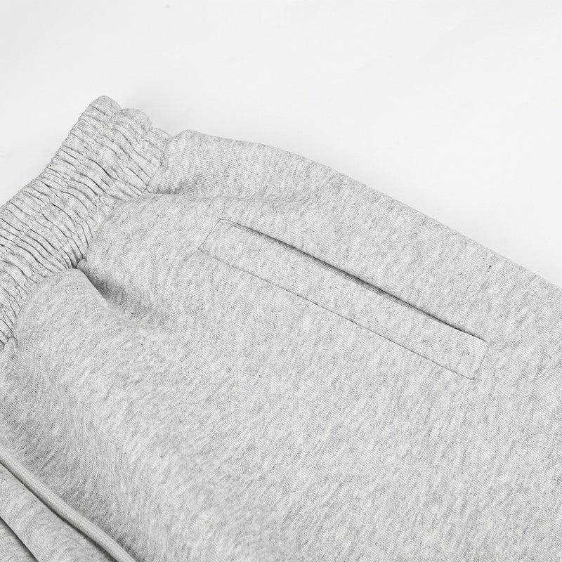 Close-up of gray sweatpants back pocket and elastic waistband