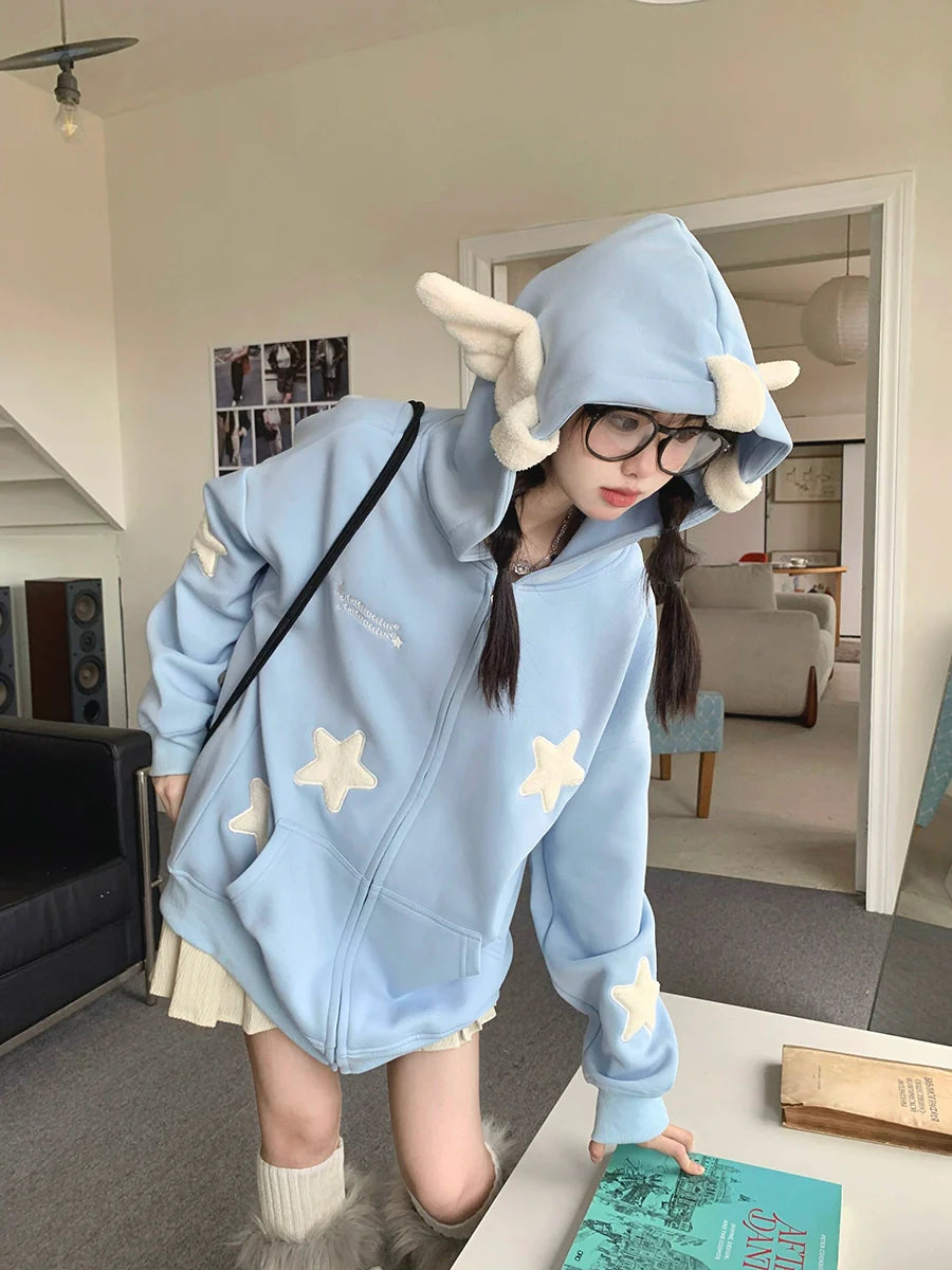 The image features a person in a whimsical outfit, wearing Seakoff's Kawaii Star Elf Hoodie with 3D ears and soft star appliques, complemented by glasses, a beige skirt, and knee-high furry boots. They exude kawaii-inspired charm amidst modern decor.
