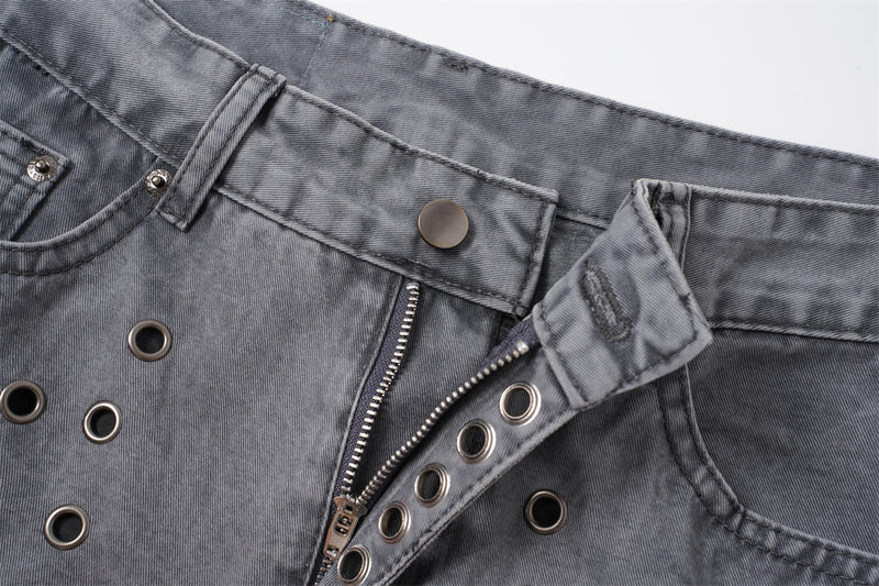 Close-up of open button fly and front waistband on washed grey jeans