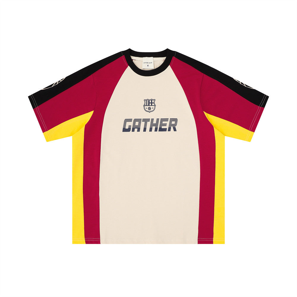 Front view of cream GATHER graphic tee with black collar, red sleeves, and yellow side panels