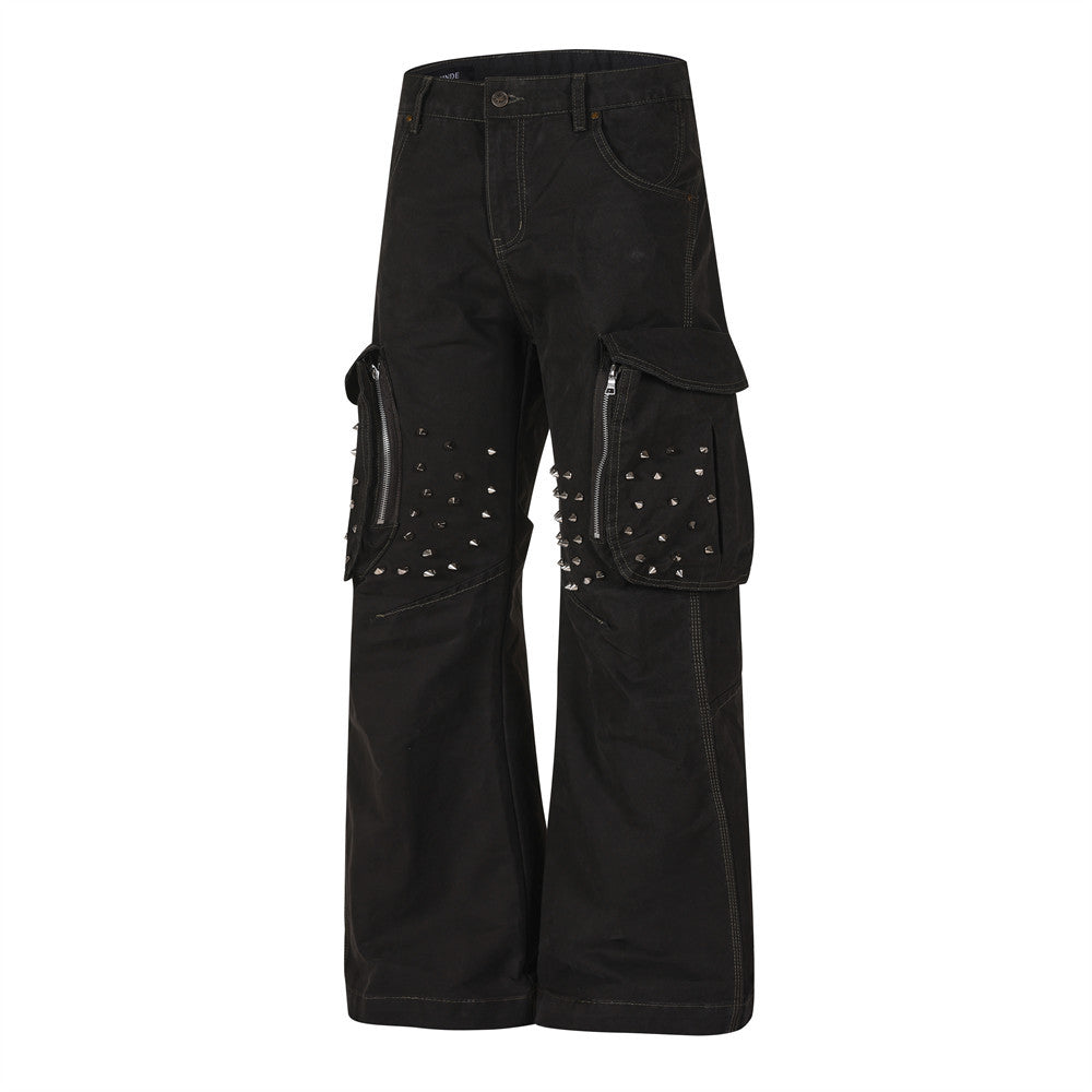Angled front view of black cargo pants showing studded side pockets and wide-leg fit