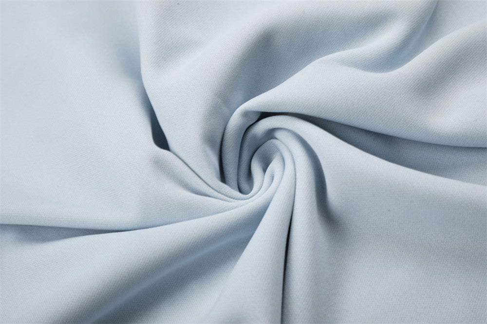 Close-up of light blue fabric draped in a swirl