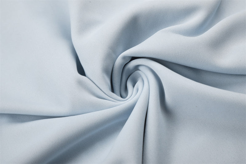 Close-up of light blue fabric draped in a swirl