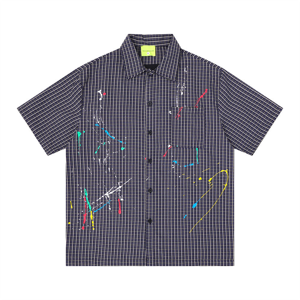 Men's oversized short sleeve plaid shirt with multicolor paint splatter embroidery on navy grid-check fabric, front and back