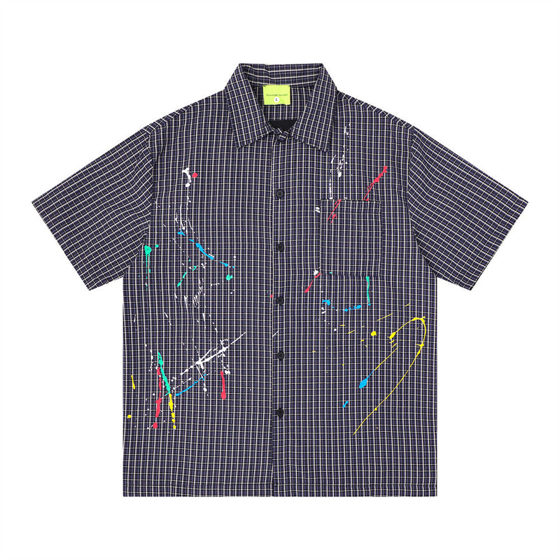 Men's oversized short sleeve plaid shirt with multicolor paint splatter embroidery on navy grid-check fabric, front and back