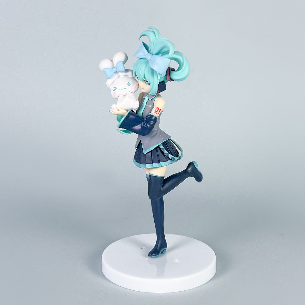 The Hatsune Miku Holding Cinnamoroll 21cm PVC Figure features the iconic character with teal twin tails in a school uniform and knee-high socks, holding a Cinnamoroll plush. It stands on a white circular base, making it a perfect collectible for anime fans.