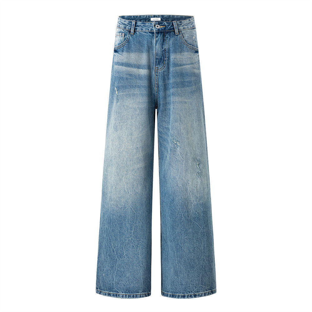 Men's wide-leg baggy jeans in gradient stonewash blue with distressed crinkle texture, front and back view