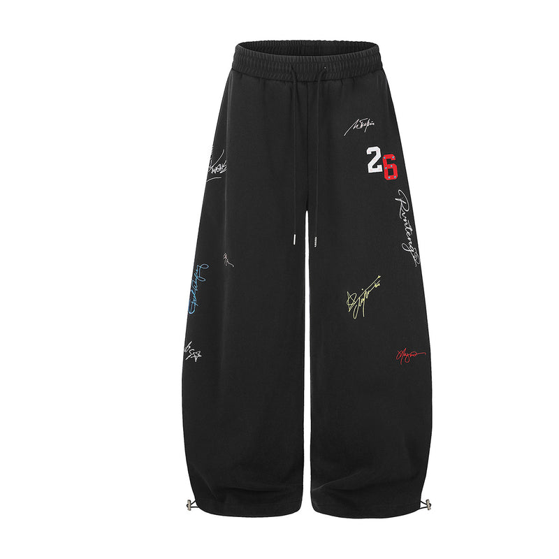 Pantalon de jogging noir à jambes larges, broderie graffiti multicolore signature, écusson numéro 26 et cordons de serrage réglables aux chevilles