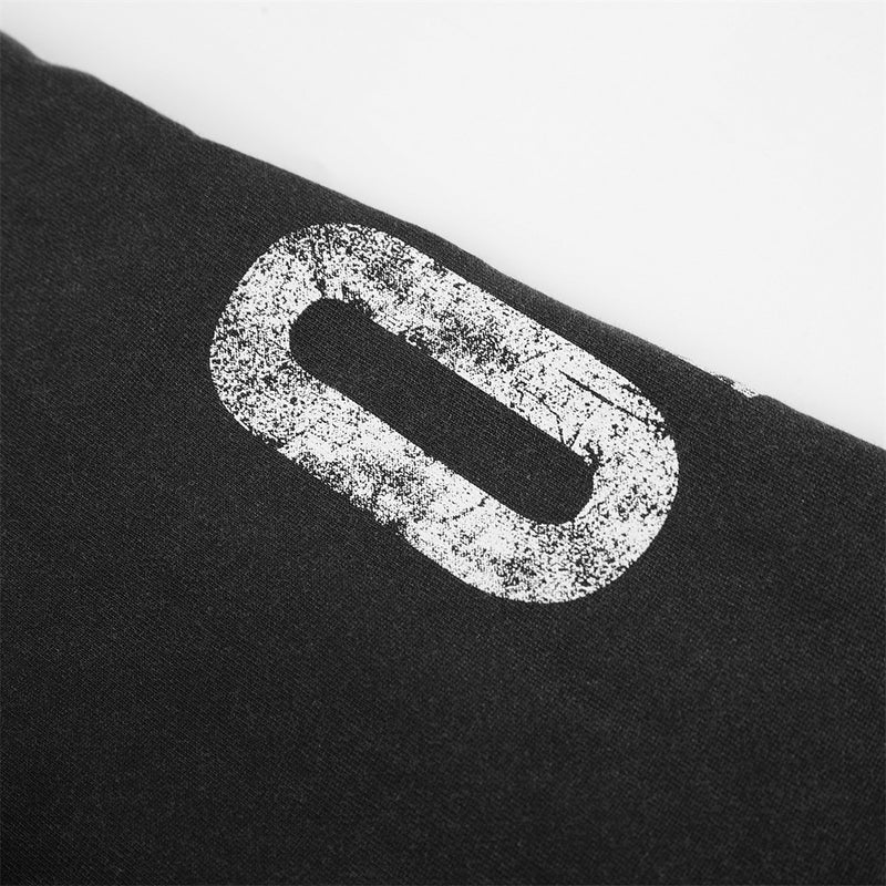 Close-up of distressed white number print on black hoodie sleeve